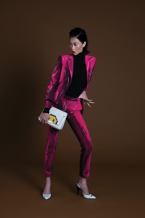Angie Ng wears suit and shoes by Moschino. bag by Anya Hindmarch and jewellery by Van Cleef & Arpels